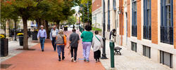 A group of people walk together in RISD's campus area of downtown Providence.