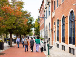 A group of people walk together in RISD's campus area of downtown Providence.